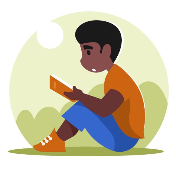 Niño leyendo un libro en el parque